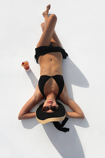 inverted woman woman lying on her back with a cocktail black hat upside down stock pictures, royalty-free photos & images