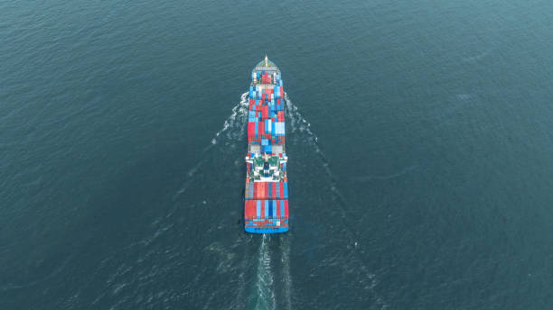 istock top view Cargo Container ship with contrail in the ocean ship carrying container and running for import export concept technology freight shipping by ship. 1727287810