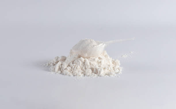 istock Protein with plastic measuring spoon on white background 1727288880