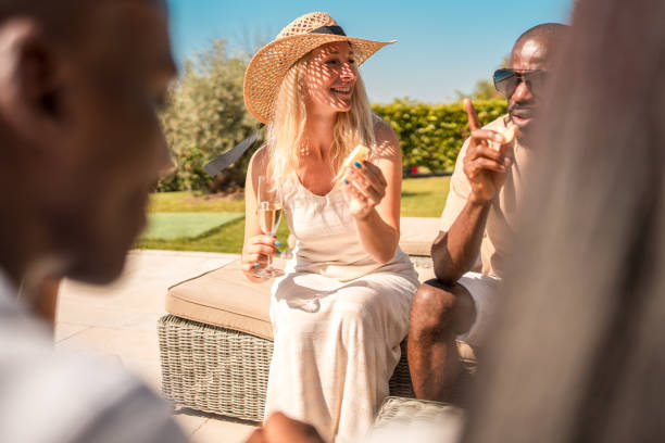 diverse couple at villa pool party bliss with friends and champagne - 13431 imagens e fotografias de stock