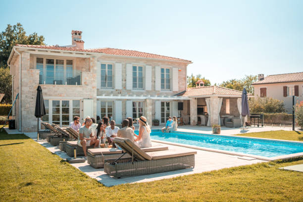 istock Sunny Idyllic Daytime Villa Poolside Party with Diverse Friends 1727293183