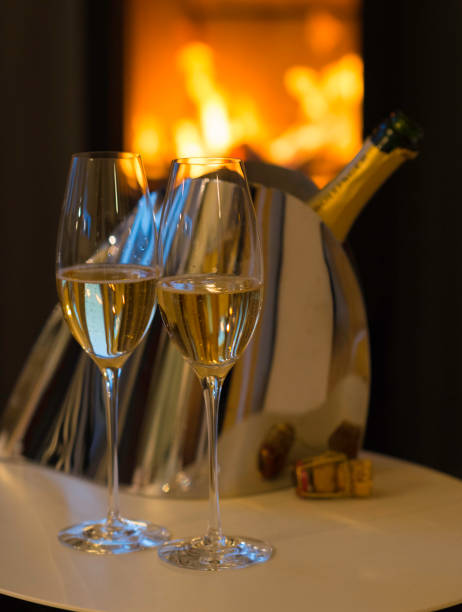 istock Champagne glasses and bottle in front of fireplace 1727293721