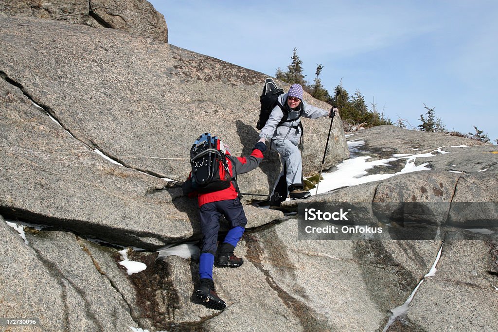 Couple Hiking and Helping Each Other to Climb Hiker helping another one to climb. Cascade Mountain, Adirondacks. 30-34 Years Stock Photo