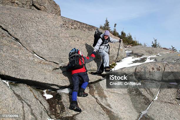 Couple Hiking And Helping Each Other To Climb Stock Photo - Download Image Now - 30-34 Years, 35-39 Years, Active Lifestyle