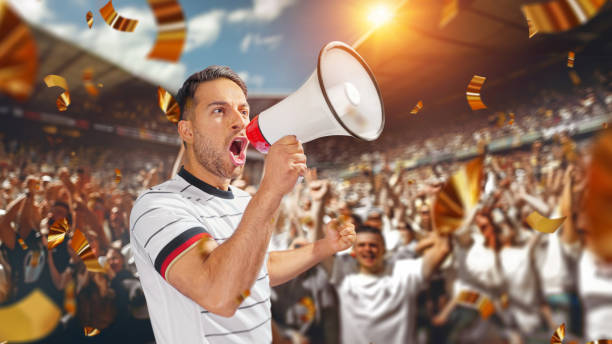 soccer fan with megaphone in hand in soccer stadium celebrating the game. soccer fan with megaphone in hand in soccer stadium celebrating the game. 2024 30 stock pictures, royalty-free photos & images