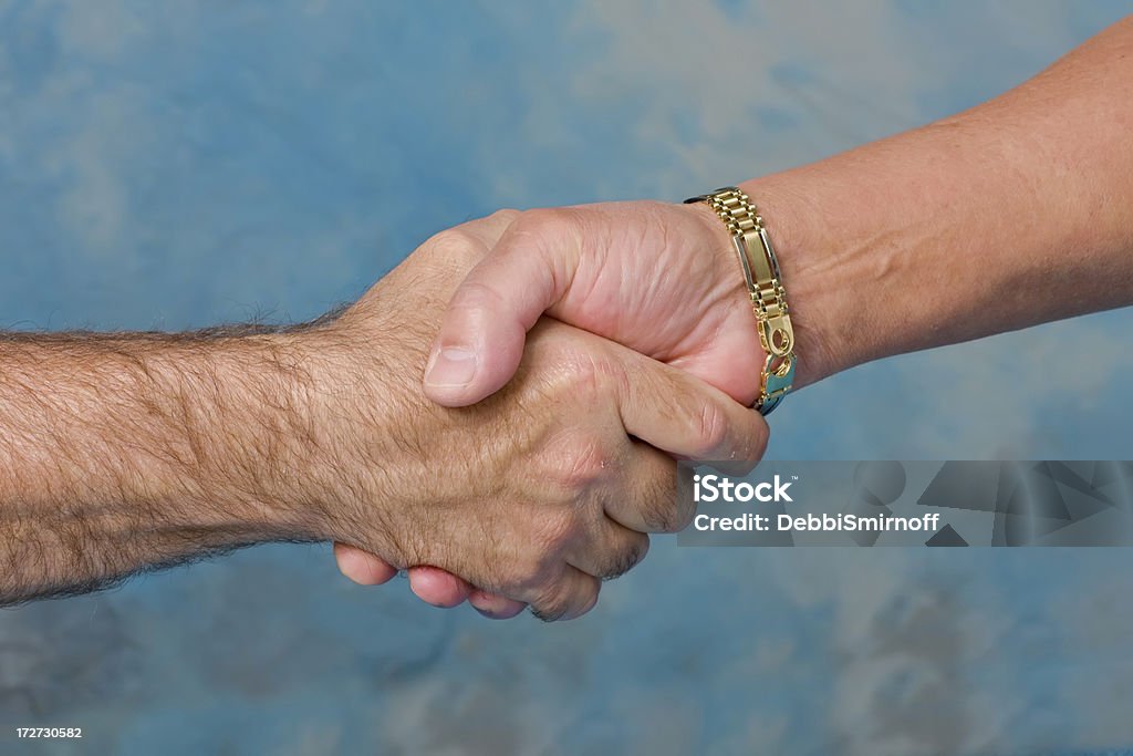 shaking hands Two hands clasping in a handshake Gay Person Stock Photo