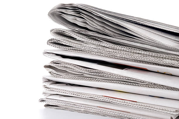 istock Pile of Newspapers Against a White Background 172730976