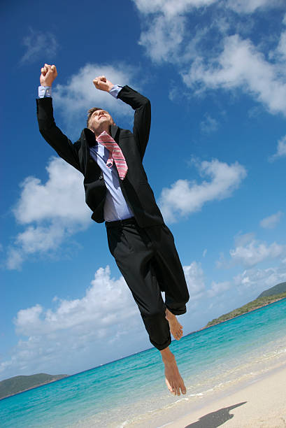 istock Barefoot Businessman Leaps Above Tropical Beach 172733028