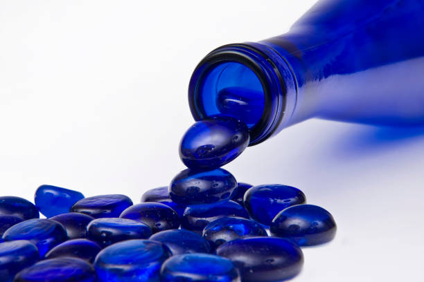 Blue glass bottle and blue glass marbles