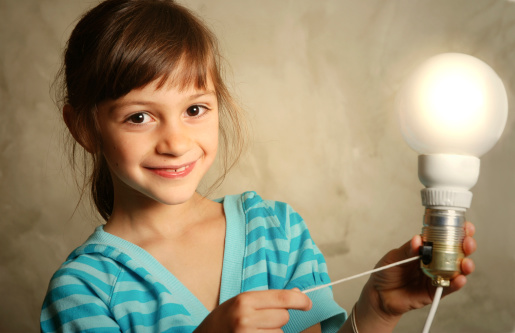 Young girl turning on a lightbulb.This model:
