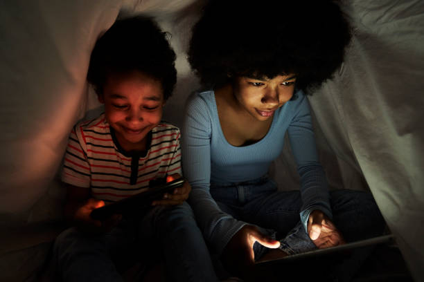 istock Two children browsing digital tablet at night under the duvet 1727342478