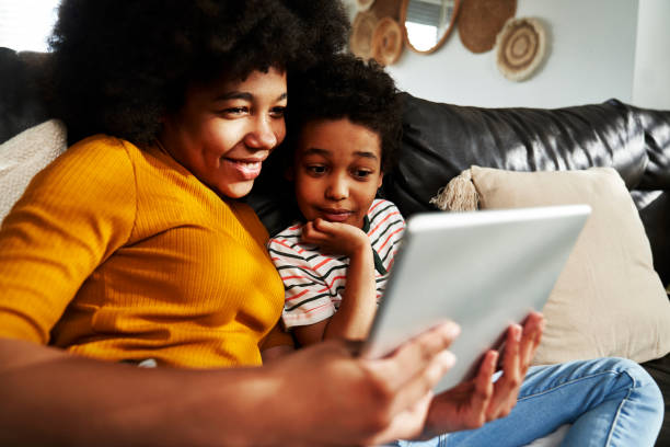 istock Two children browsing digital tablet in the living room 1727343514