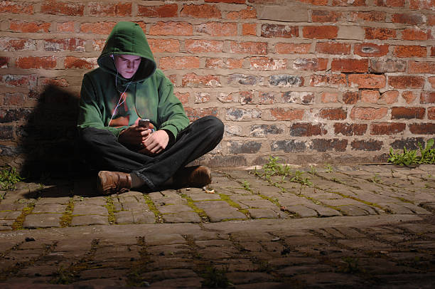 istock young hoodie texts through the loneliness 172734563