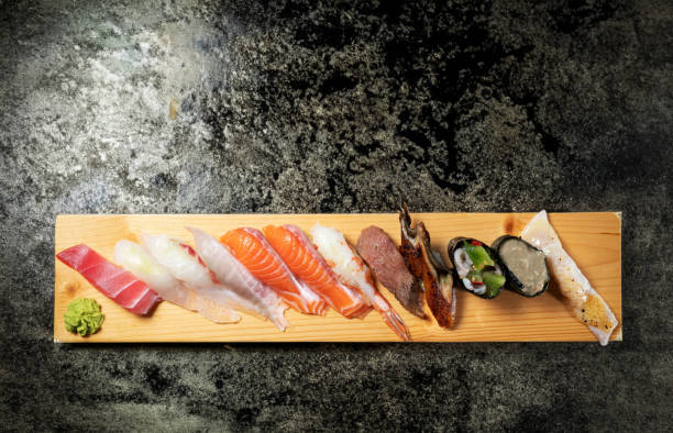 Different types of sushi on a wooden plate