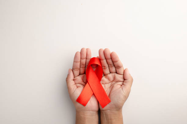 istock AIDS ribbon in hand isolated on white background 1727358103