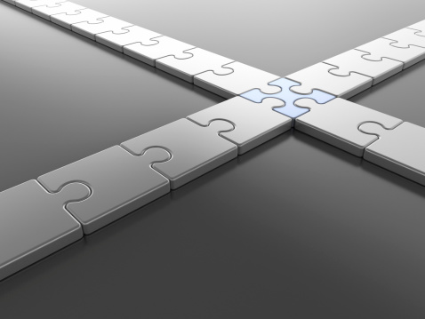 Royalty free 3d business concept rendering of jigsaw puzzle piece connecting four strands.