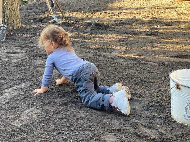 istock Toddler girl working in garden 1727361668