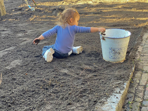 istock Toddler girl working in garden 1727361908