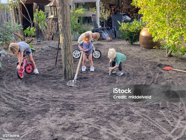 Grandchildren Working In Garden Stock Photo - Download Image Now - 12-23 Months, 18-23 Months, 2-3 Years