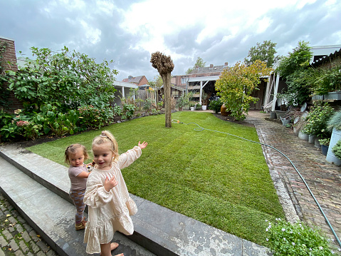 Grandschildren watching the  garden with new  new Grass