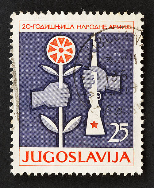 istock Yugoslavian stamp with gun and flower 172736359