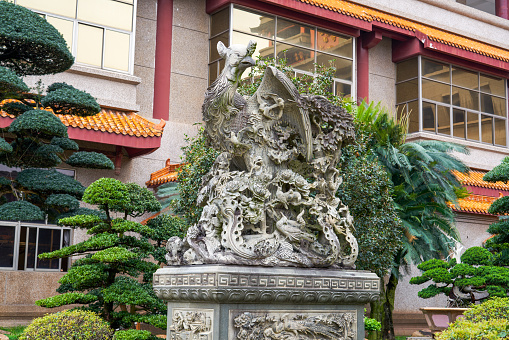 Ancient Chinese traditional mythical animal sculptures in a luxurious Chinese garden