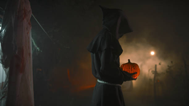 istock Monk with Halloween Pumpkin In a Dark Night 1727366811