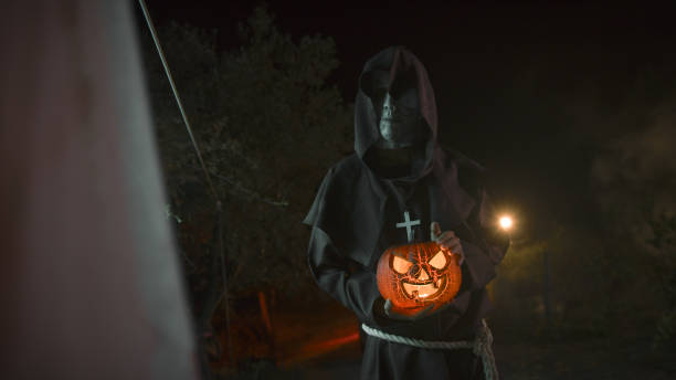 istock Monk Caress The Halloween Pumpkin In a Dark Night 1727367873