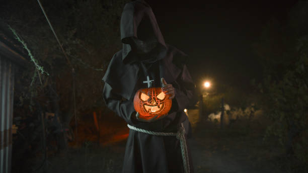 istock Monk Caress The Halloween Pumpkin In a Dark Night 1727367893
