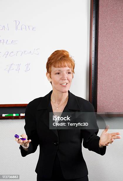 Woman Instructor Explaining Business Finance Concept To Class Stock Photo - Download Image Now