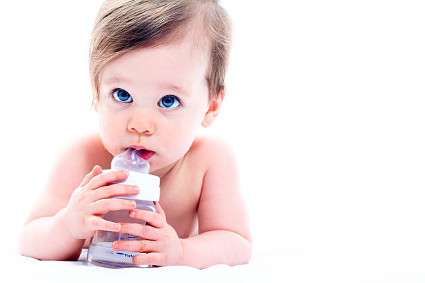 Cute baby with a bottle stock photo