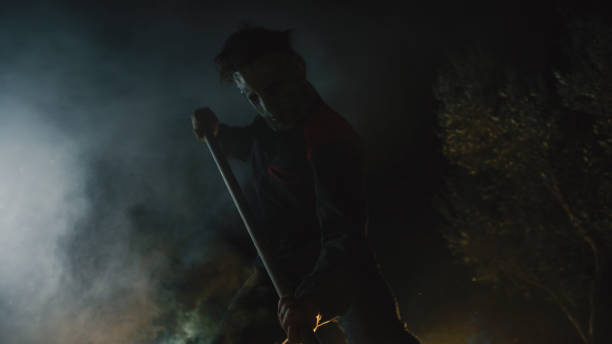 istock Masked man digs a hole in the ground 1727372981