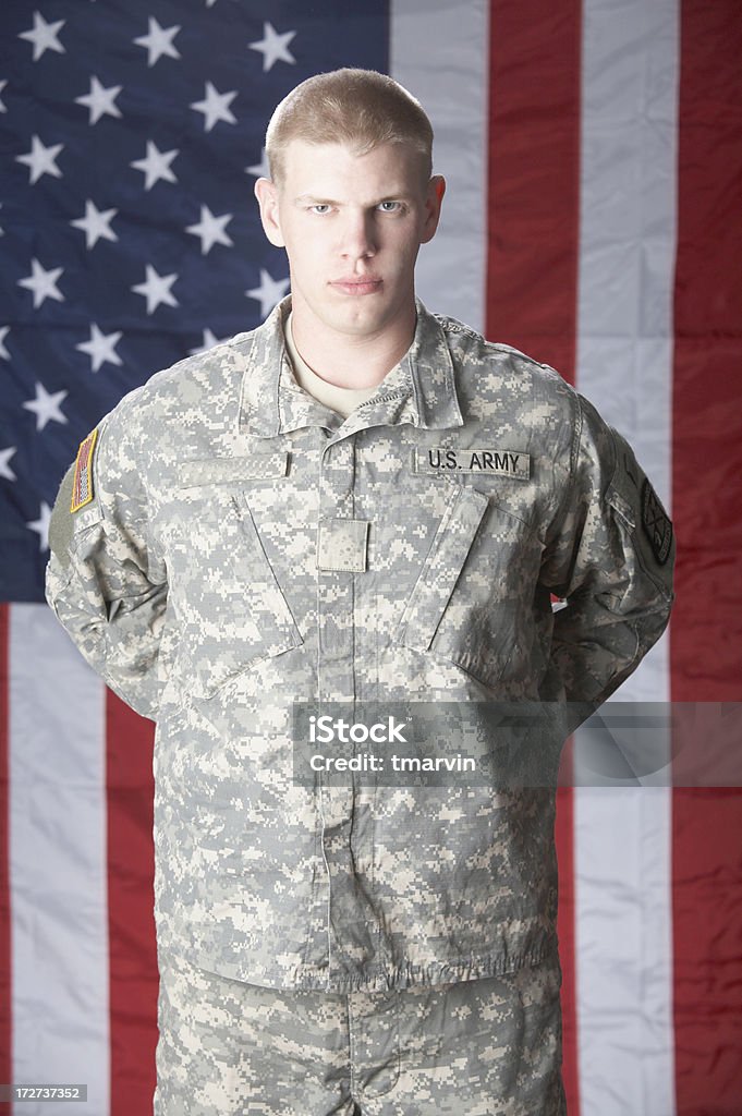 Military man A young U.S. Army soldier stands in front of the U.S. flag. Shot with Canon 5D. 20-24 Years Stock Photo