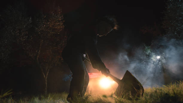 istock Masked man digs a hole in the ground 1727374638