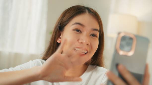 istock Attractive young asian woman using mobile phone making video call 1727376986