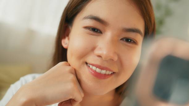 istock Attractive young asian woman using mobile phone making video call 1727376993
