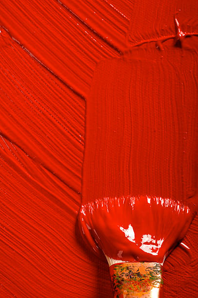Large artist brush painting with red acrylic on canvas.