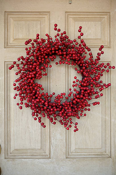 istock Red berry wreath against an ivory colored door  172737910