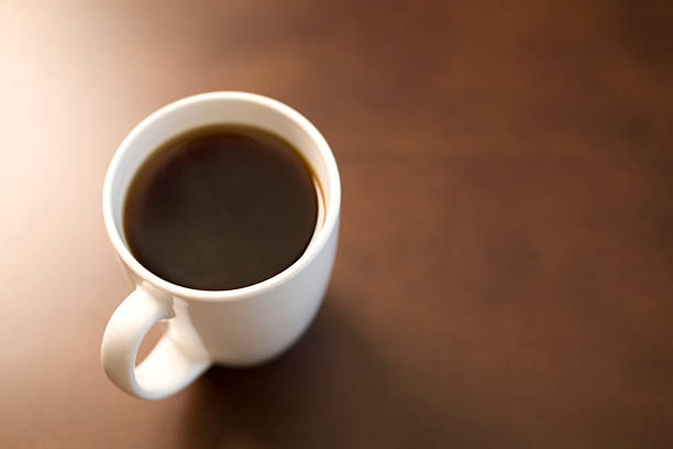 Coffe cup on brown table. stock photo