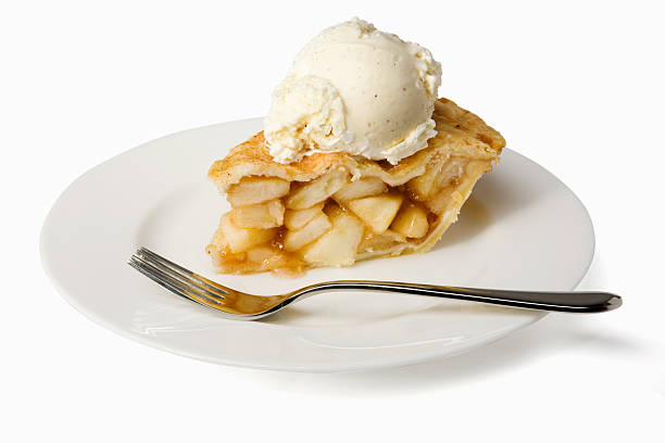 Slice of apple pie a la mode on a plate with a fork Apple pie with a scoop of vanilla ice cream.  Isolated on white with clipping path. apple pie photos stock pictures, royalty-free photos & images