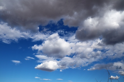 A beautiful, serene cloudy blue sky with wispy white clouds scattered throughout