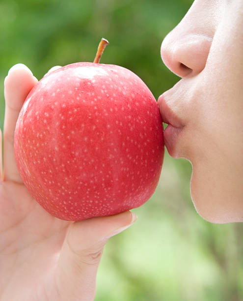 istock Young woman kissing an apple 172740068