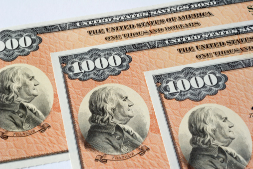 Detail photograph of three $1000 U.S. Savings Bonds.