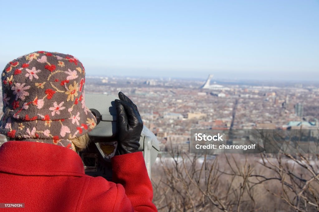 Tourist on Mount Royal in Montreal Quebec Tourist on Mount Royal in Montreal Quebec using binoculars to see the Olympic Stadium and the St. Lawrence Seaway. (Fleuve St. Laurent) Adult Stock Photo