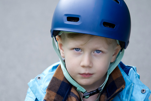 Little boy in a bicycle helmet  looking at the camera copy space