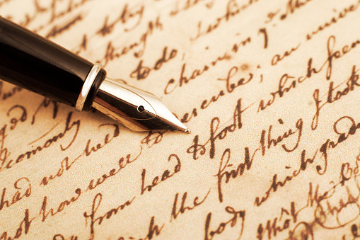 Calligraphy pen and letter closeup photo