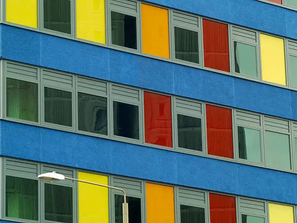 A city-centre office building with multi-coloured panels.