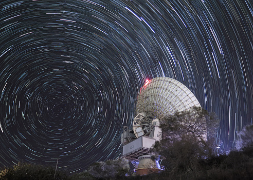 Carnarvon Satellite dish with southern cellestial stars spinning around dish .  Australia