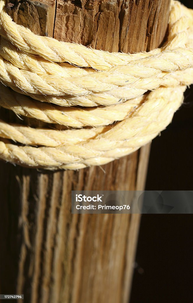 Twine Rope and Post rope tied around wooden post. Abstract Stock Photo