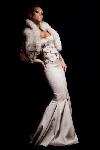 Model wearing evening gown and fur stola.